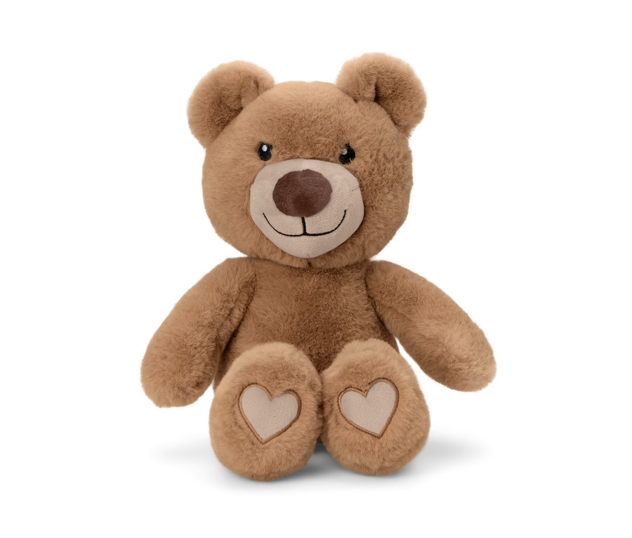 Un animal en peluche marron « ours » est assis sur un fond blanc.