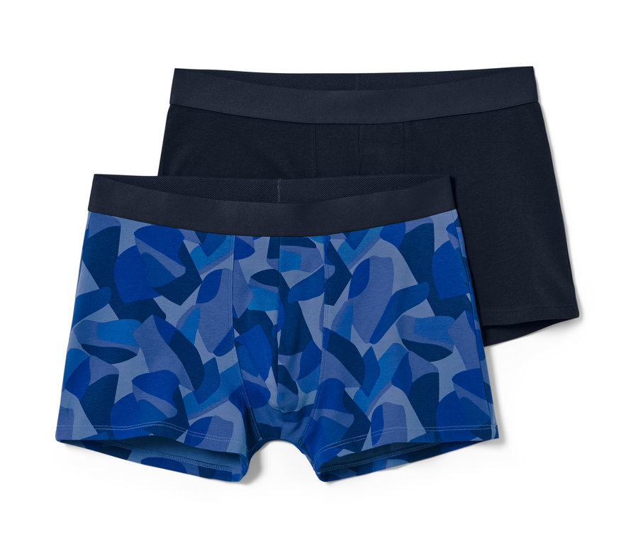 Deux boxers, un bleu à motifs, un bleu foncé.