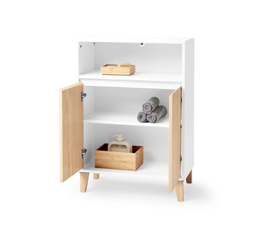 Un meuble de rangement blanc avec deux portes et un espace ouvert, contenant des serviettes et un distributeur de savon.