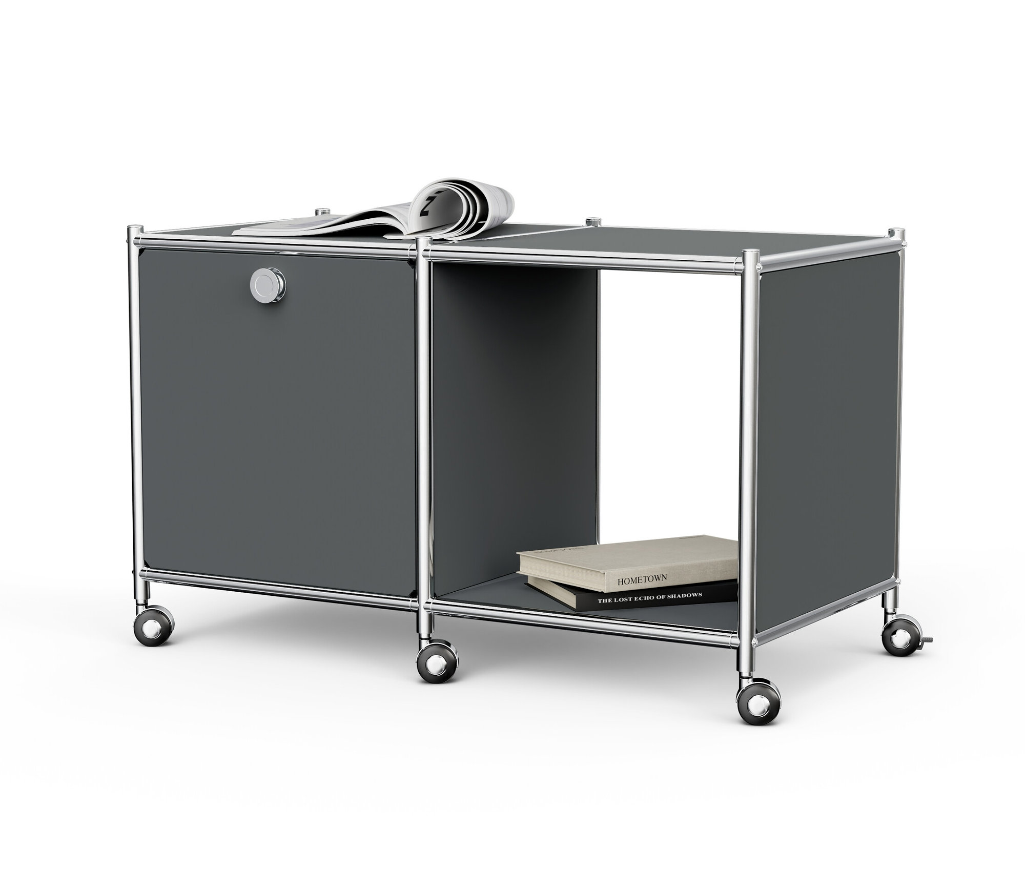 Table d’appoint métallique grise « CN3 » avec 1 abattant, roulettes, un journal sur le dessus et des livres dans le compartiment ouvert.