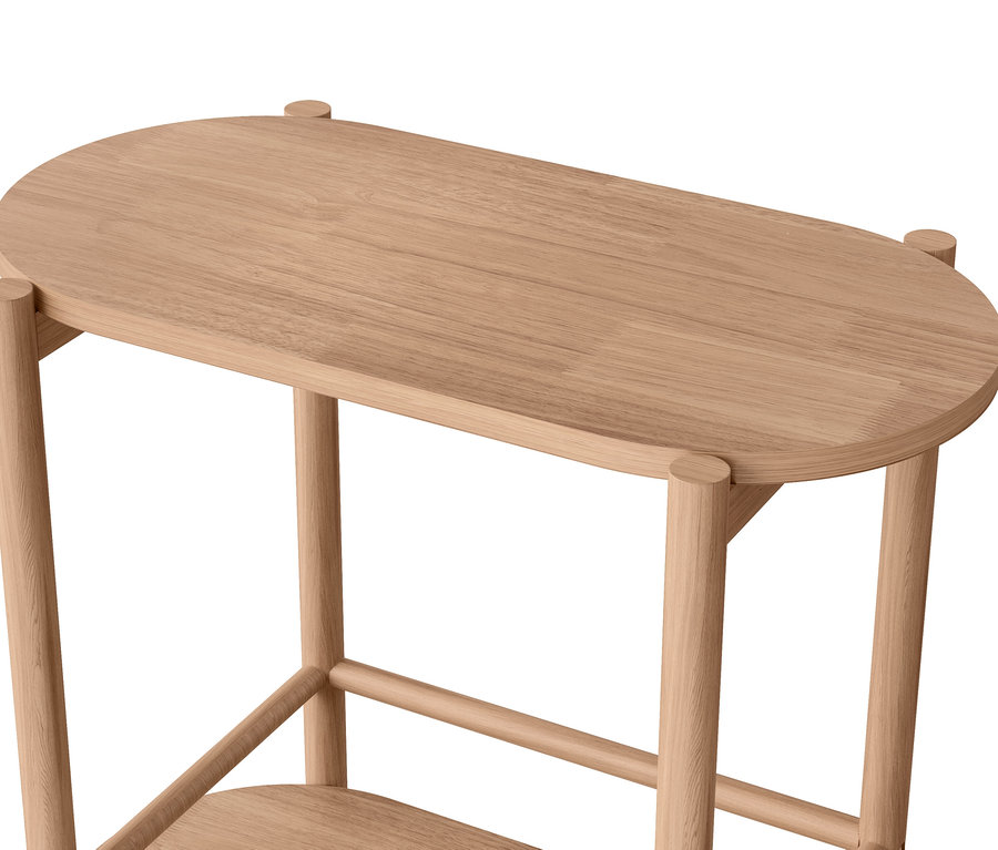 Détail d'une table en bois à deux niveaux avec des coins arrondis.