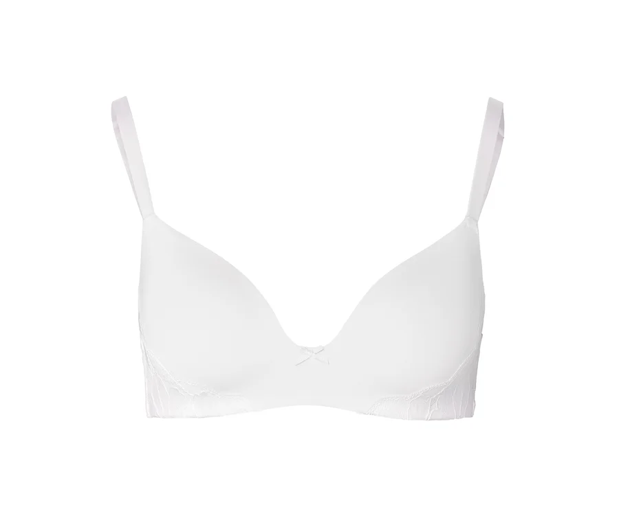 Soutien-gorge à coques souples blanc avec bretelles réglables, petit nœud et dentelle délicate sur les côtés.