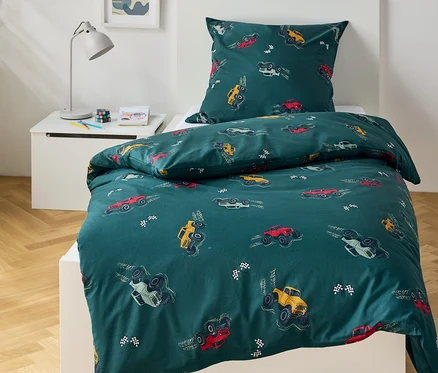 Literie verte avec motif de monster trucks sur un lit.