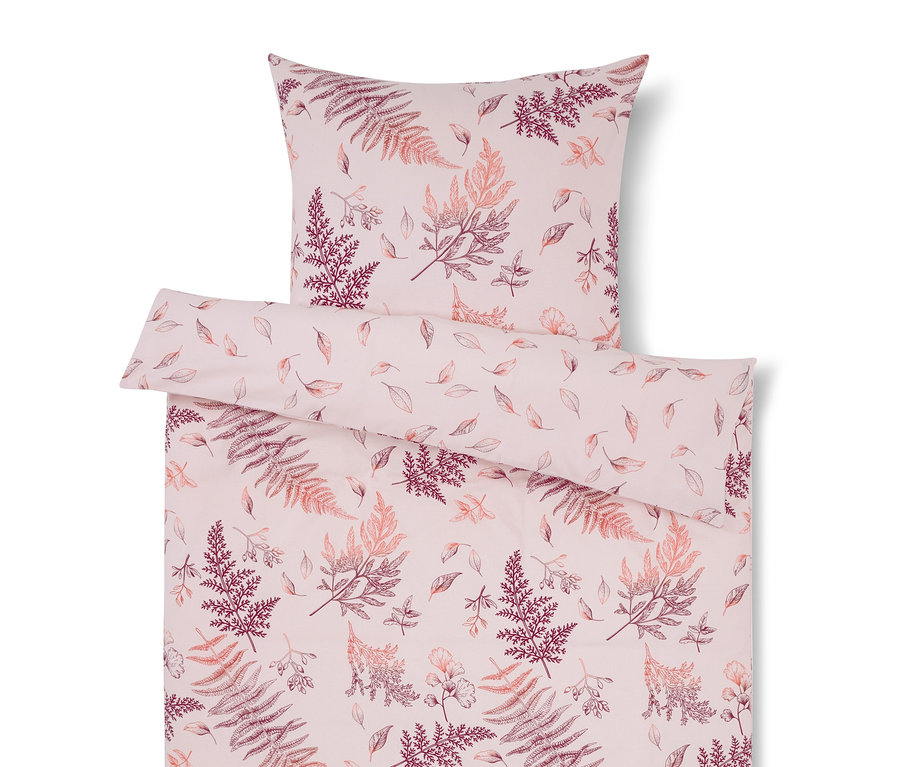 Linge de lit rose avec motif de feuilles.