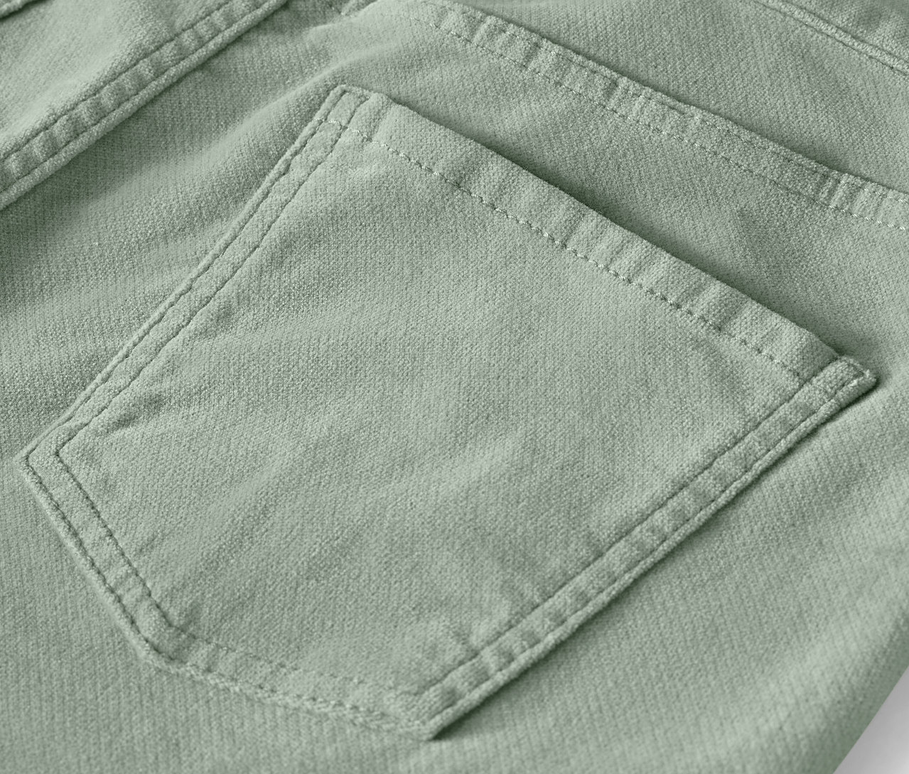 Détail d'une poche arrière d'un pantalon vert clair.