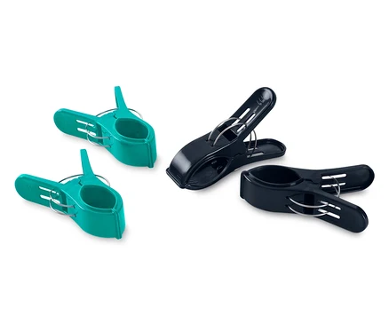 Deux pinces à linge turquoise et deux pinces à linge noires sont posées sur un fond blanc.