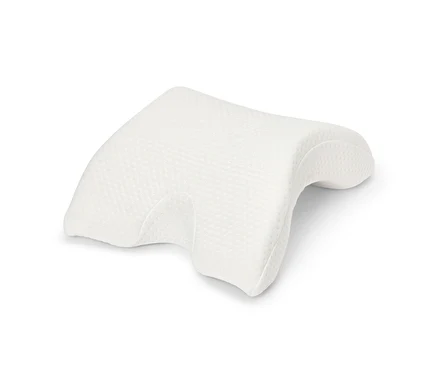 Un oreiller orthopédique blanc sur fond blanc.