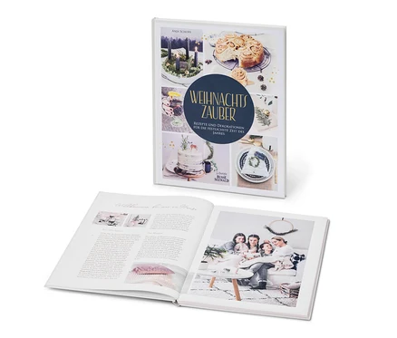 Deux livres : l’un fermé avec des images d’une couronne de l’Avent, de pâtisseries et d’un gâteau, et l’autre ouvert avec une photo d’une famille dans un salon. Le livre « Weihnachtszauber » (« Magie de Noël ») est également visible.