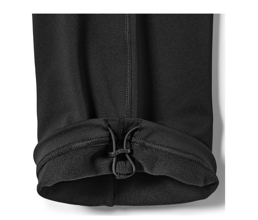 Détail d'un pantalon thermique noir avec cordon de serrage à l'ourlet.