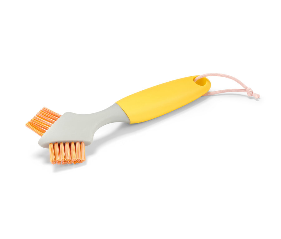 Brosse de nettoyage pour joints avec manche jaune, col gris et poils orange.