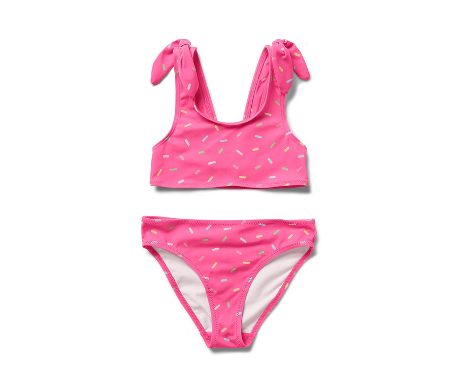 Un bikini deux pièces pour enfants de couleur rose avec des motifs de confettis colorés.