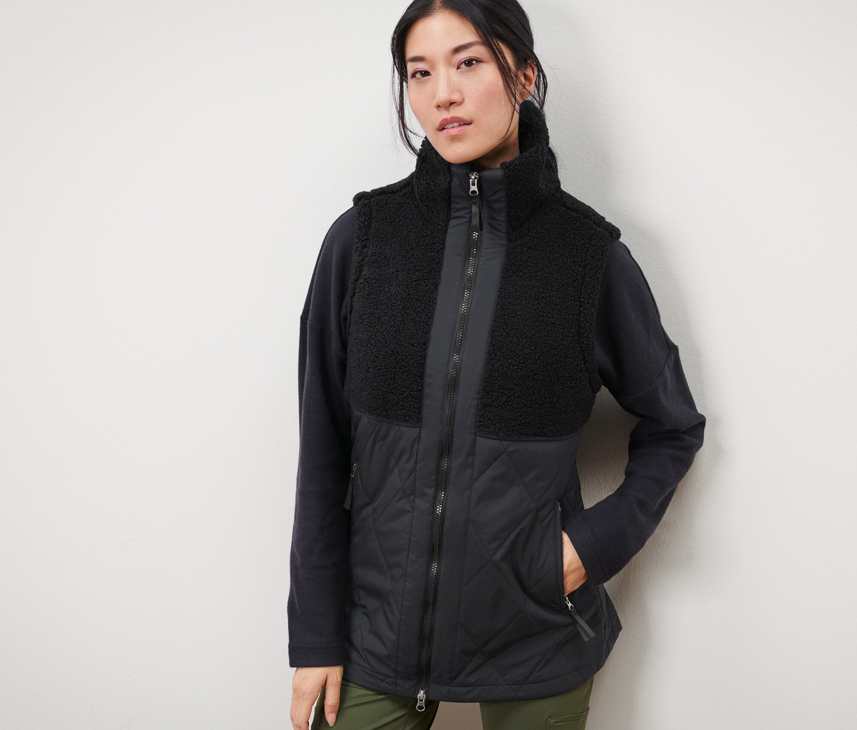 Femme portant un gilet matelassé sans manches en peluche teddy.