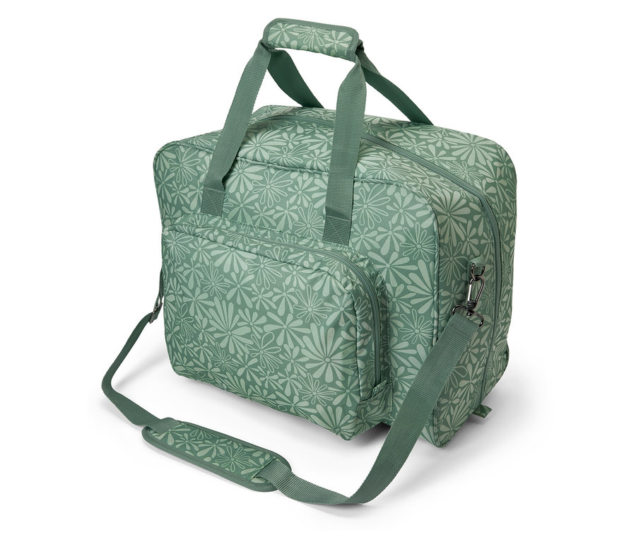 Un sac de machine à coudre vert avec un motif floral.