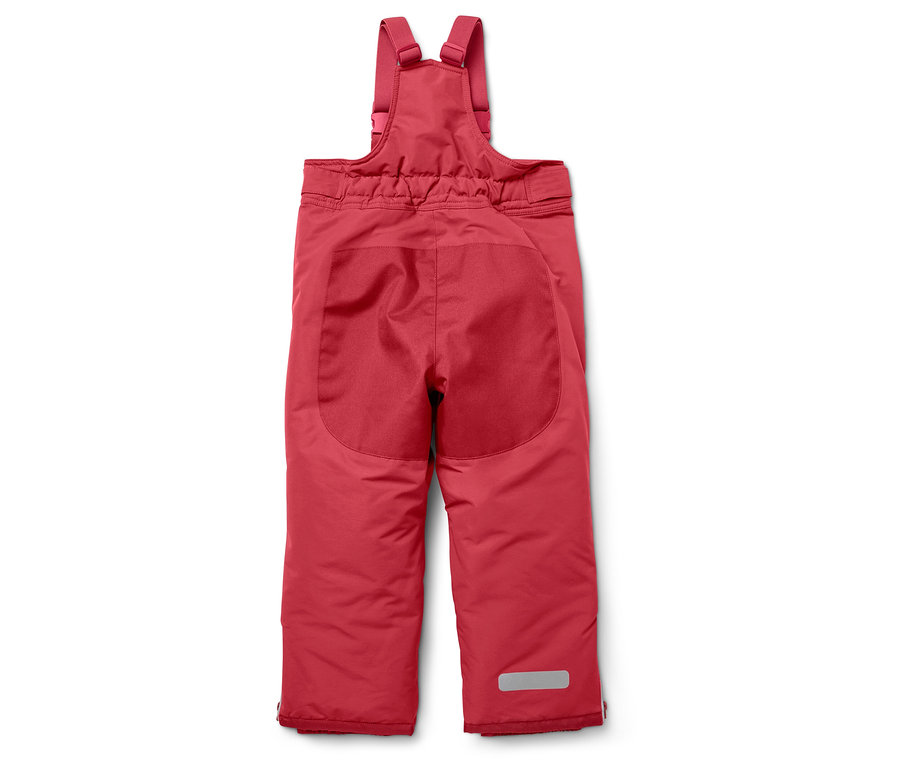 Pantalon de ski rouge pour enfant avec bretelles sur fond blanc.