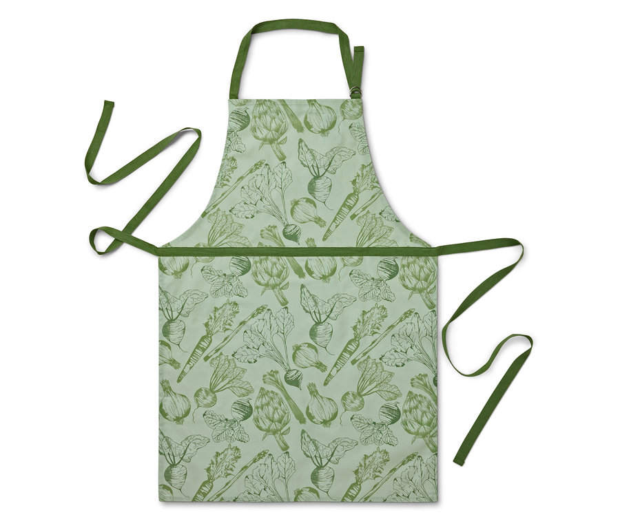 Un tablier avec un imprimé de légumes sur un fond vert clair.