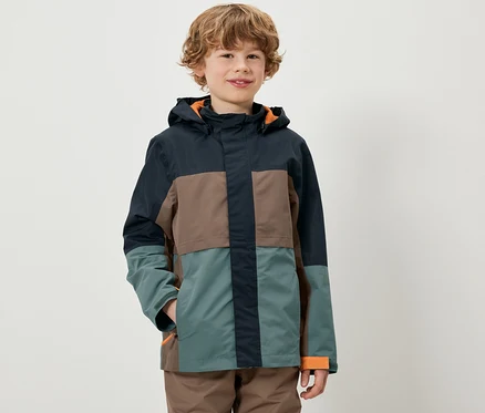 Un garçon porte une veste colorée pour enfant tout temps.