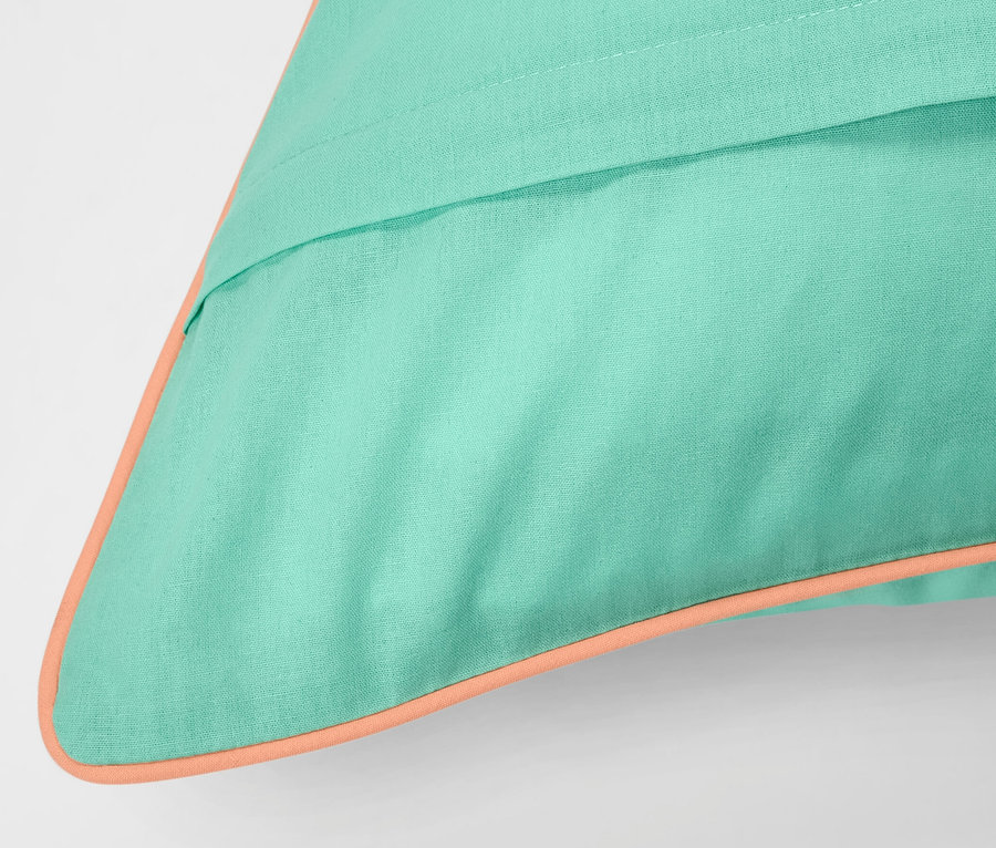 Détail d'une parure de lit en renforcé turquoise de taille standard avec une bordure orange.