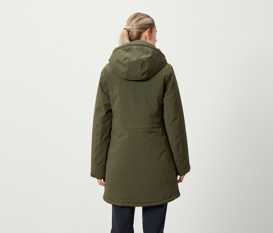 Vue arrière d'une femme aux cheveux blonds attachés en queue de cheval portant une veste d'hiver vert olive à capuche.