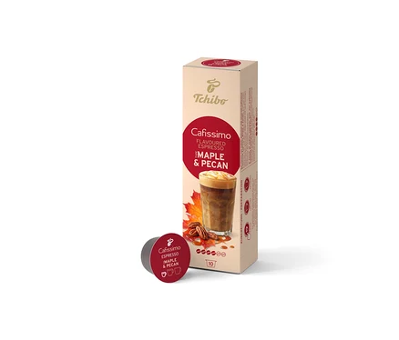 Une boîte beige de 10 capsules Cafissimo Flavoured Espresso Érable & Noix de Pécan est debout, avec une capsule rouge foncé devant. La boîte montre une boisson au café, des feuilles d'érable et des noix de pécan.