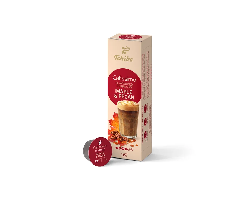 Une boîte beige de 10 capsules Cafissimo Flavoured Espresso Érable & Noix de Pécan est debout, avec une capsule rouge foncé devant. La boîte montre une boisson au café, des feuilles d'érable et des noix de pécan.