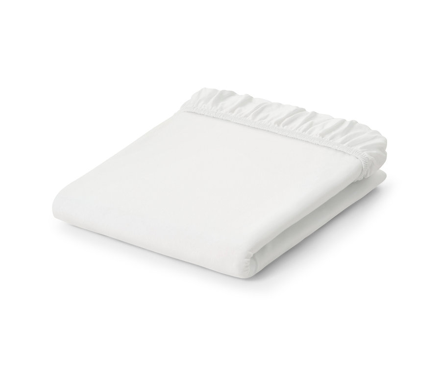 Drap-housse en jersey blanc plié.