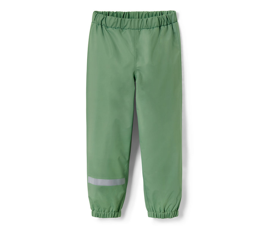 Pantalon de pluie pour enfant vert gazon avec une bande réfléchissante sur la jambe.