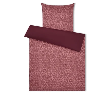Linge de lit à motif floral dans les tons rose et bordeaux, comprenant une taie d'oreiller et une housse de couette.