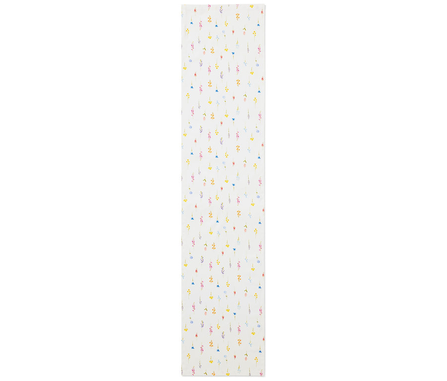 Un chemin de table avec un motif floral jaune, bleu, rose et rouge sur un fond blanc.