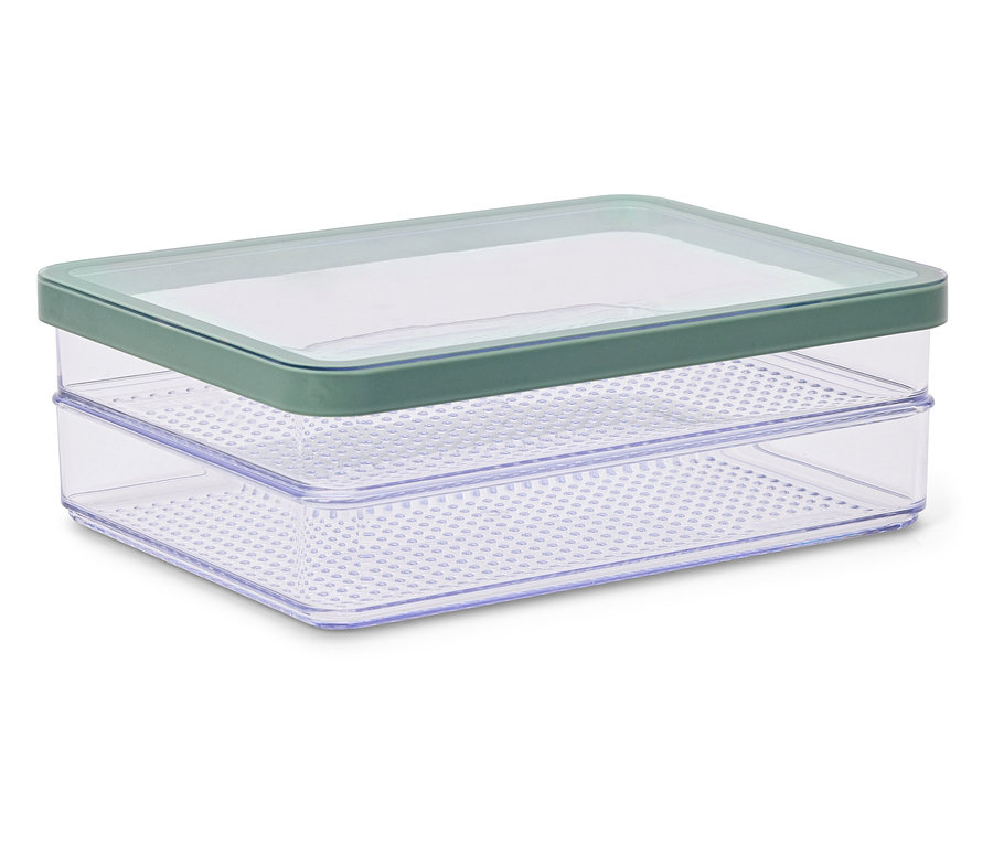 Germoir transparent à deux niveaux avec trous et couvercle vert, posé sur une surface blanche.