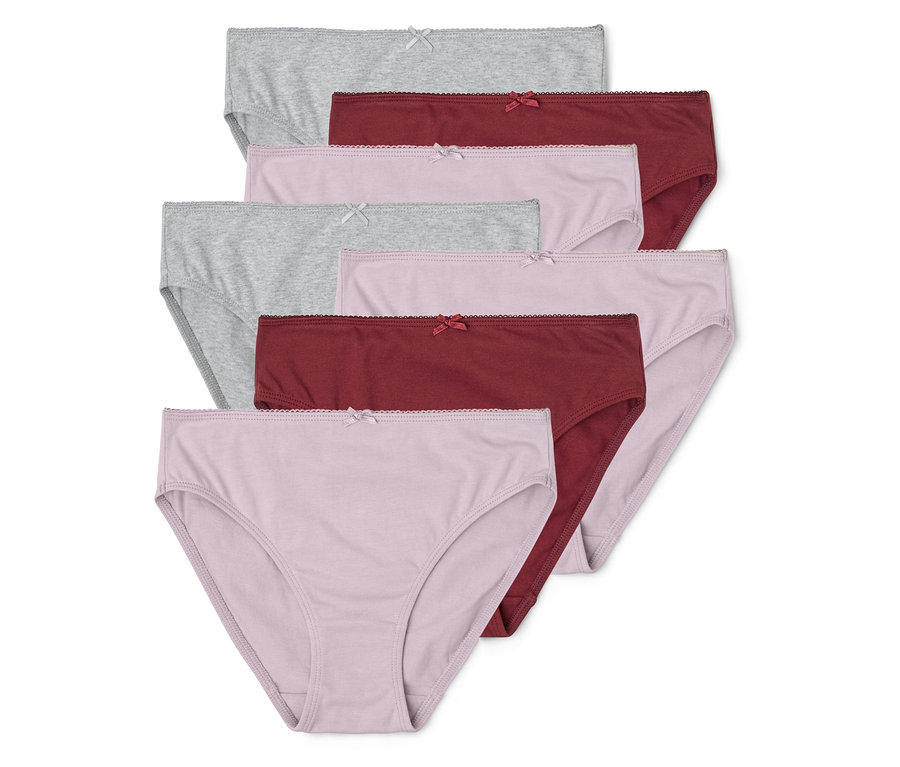Pile de sept culottes en coton gris, rose et bordeaux avec un nœud sur fond blanc.