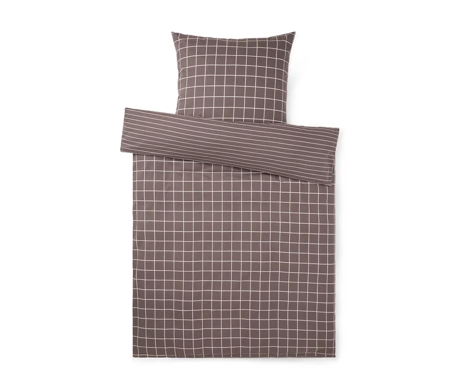 Parure de lit marron avec motif à carreaux blancs et revers rayé.