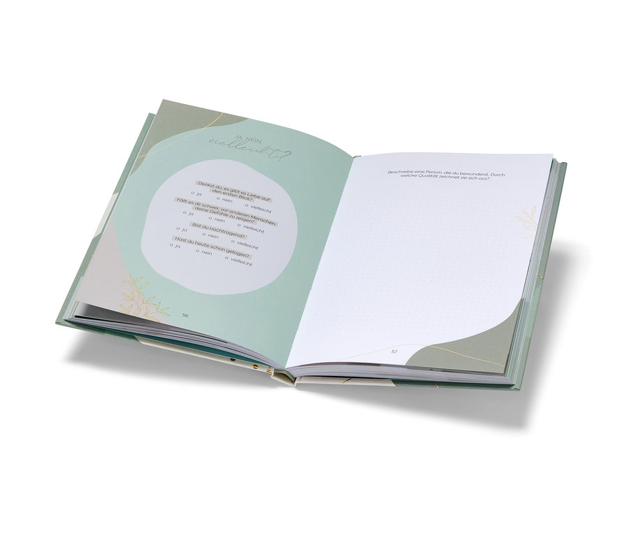 Livre ouvert « Deine Verabredung mit dir selbst » avec des questions et des pages blanches.