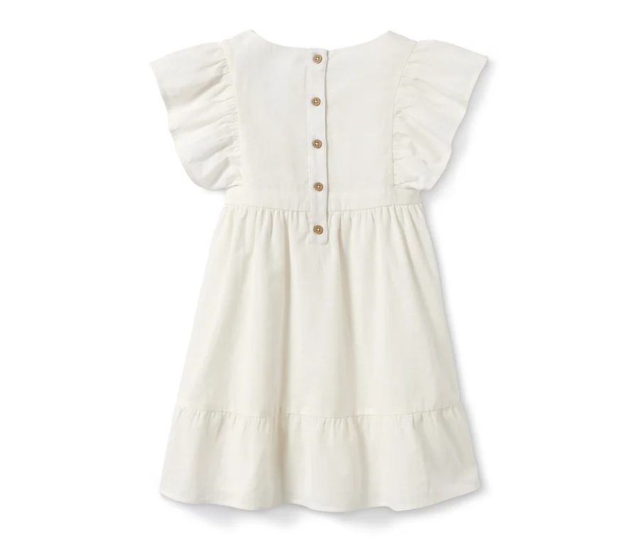 Vue détaillée de l'arrière d'une robe tissée en coton bio avec des boutons.