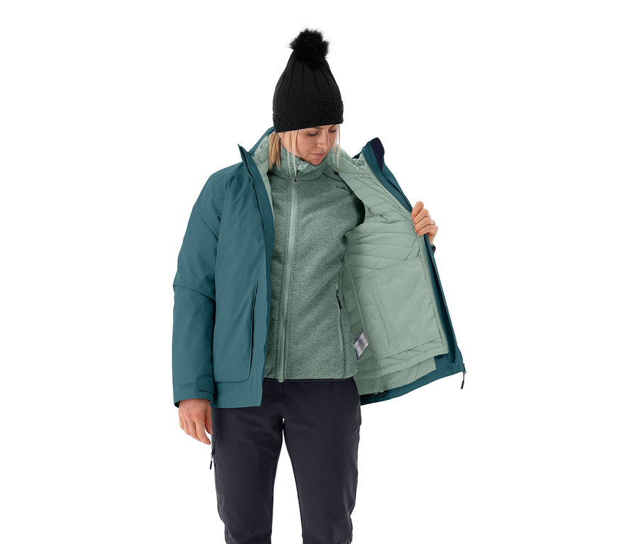 Une femme ouvre une veste multifonctionnelle CMP pour femmes, elle porte un bonnet noir à pompon, une veste en polaire et un pantalon noir.