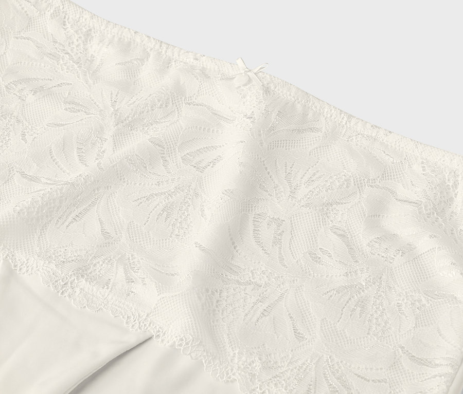 Gros plan sur une culotte couleur crème avec une bordure en dentelle.