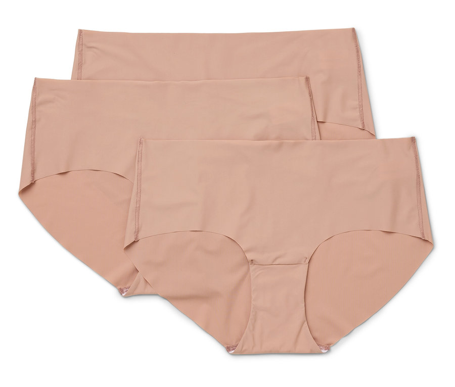 Trois culottes couleur chair pour femmes sont superposées.