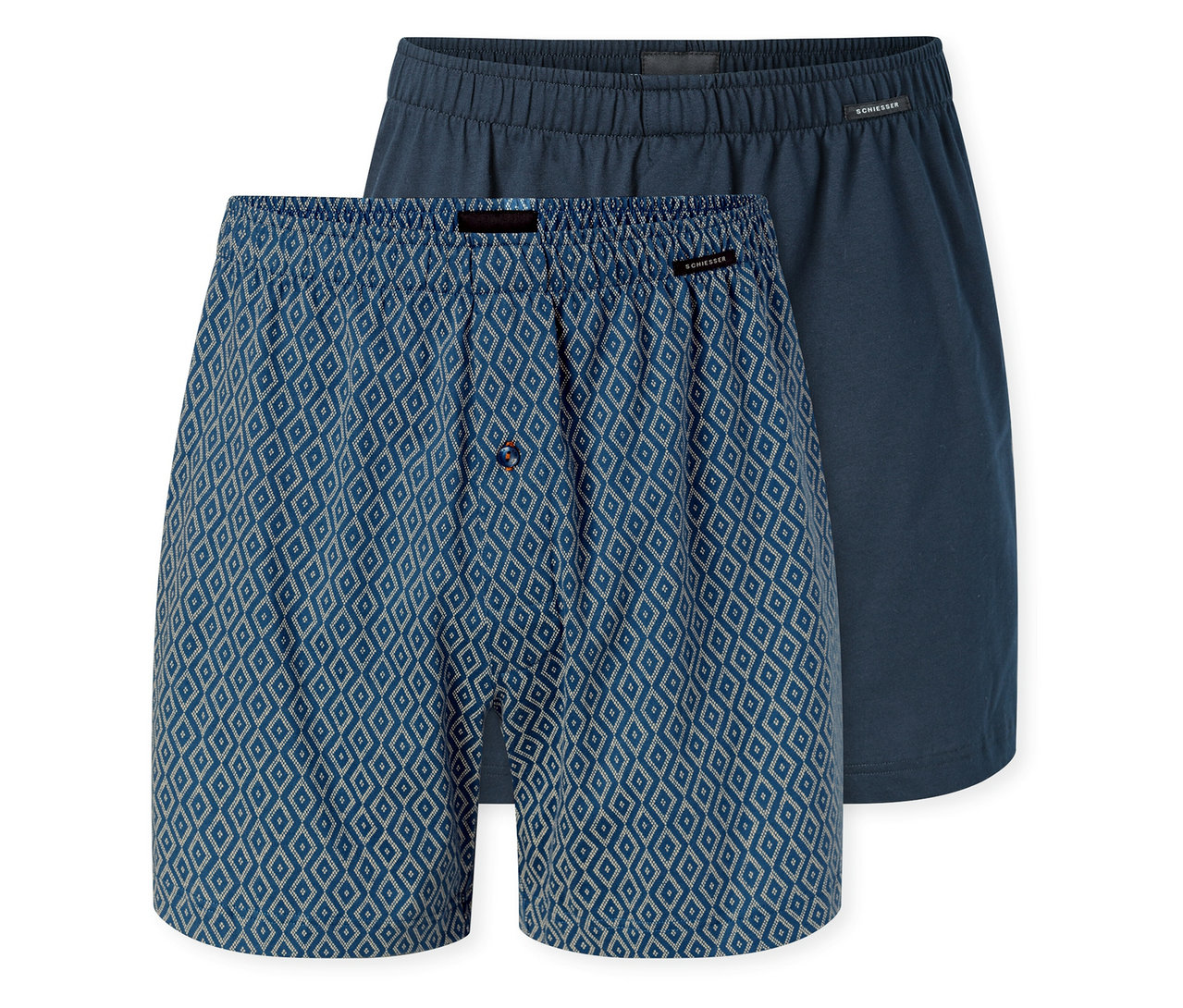Deux boxers en jersey SCHIESSER; l'un bleu à motif losanges blancs avec une braguette boutonnée, l'autre bleu foncé uni.