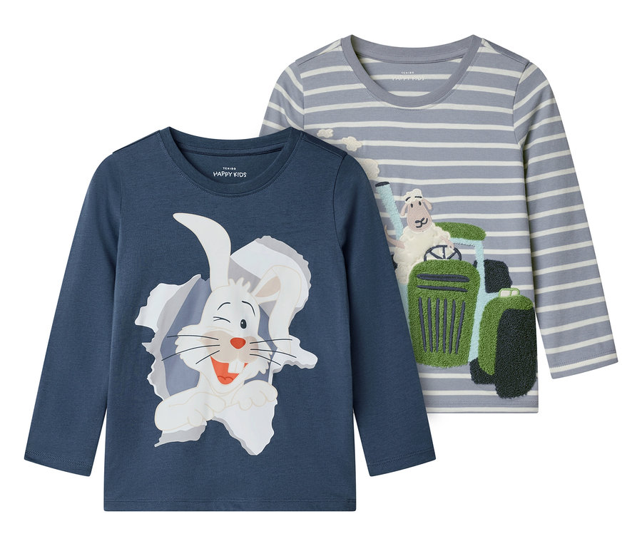 Deux t-shirts à manches longues pour enfants sont côte à côte. L'un est bleu avec un lapin blanc, l'autre est gris rayé avec un mouton sur un tracteur.