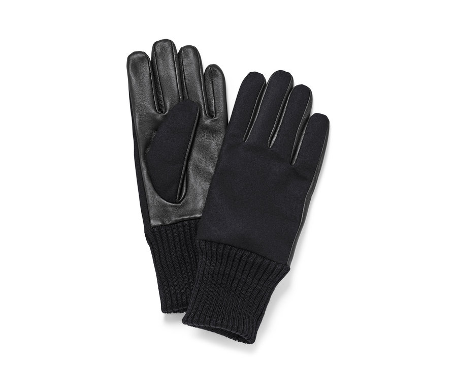Deux gants en cuir noirs sont posés l'un à côté de l'autre.