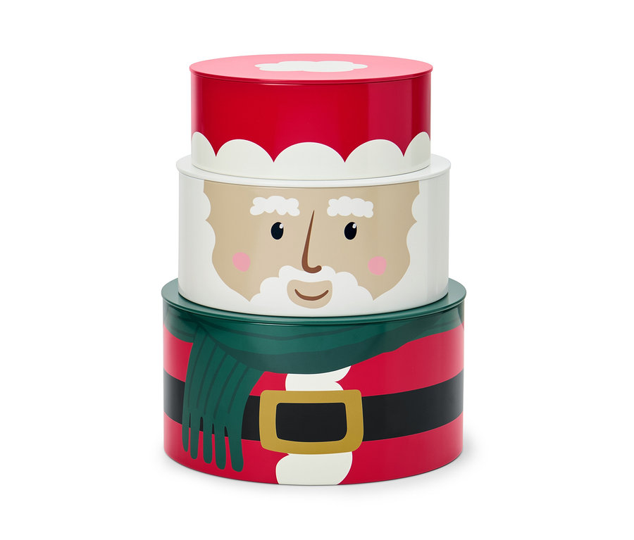 Un ensemble de trois boîtes à biscuits avec des motifs de Noël, empilées les unes sur les autres.