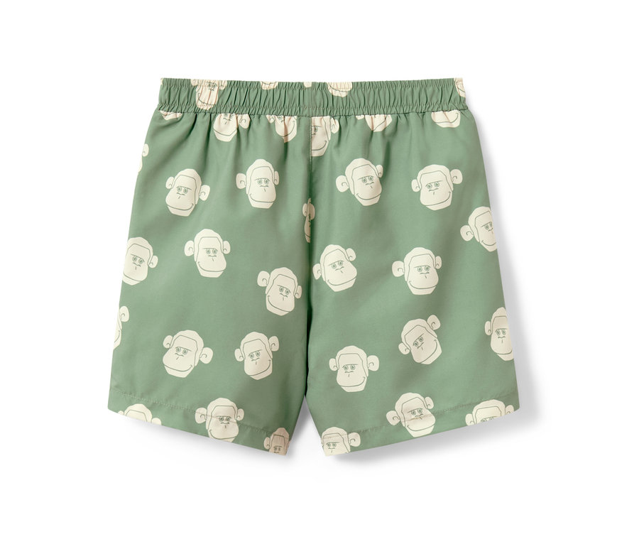 Short de bain vert pour enfant avec motif de singes.