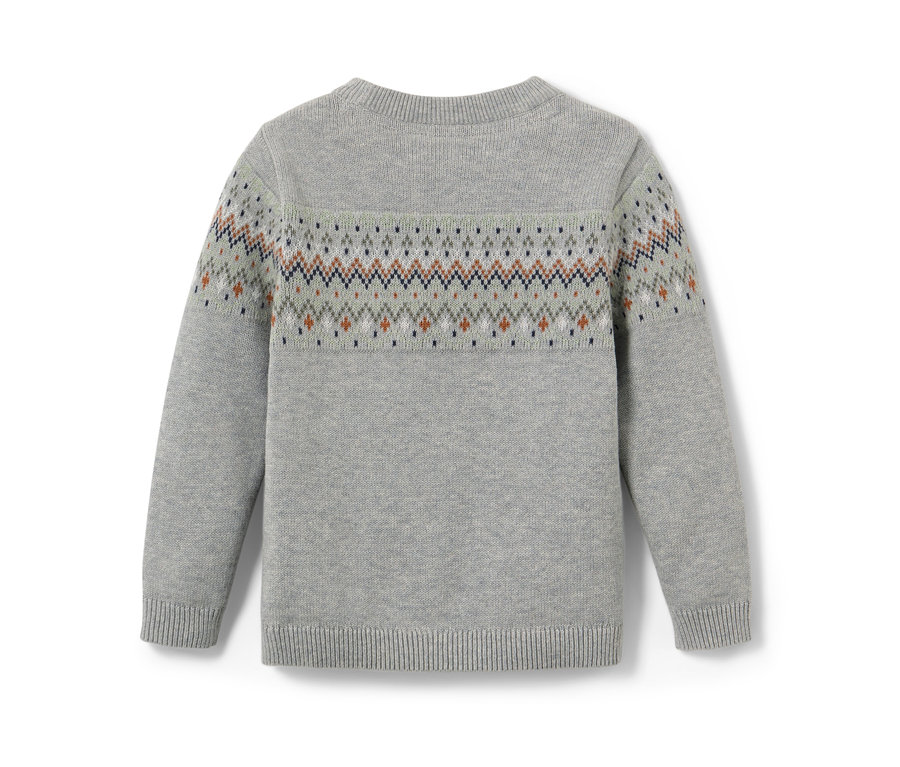 Gros plan sur un pull en maille pour enfant avec un motif.