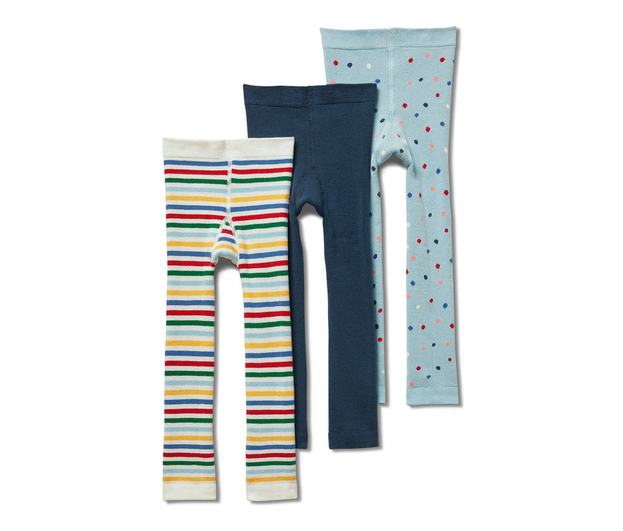 Trois leggings thermiques pour enfant : un à rayures, un bleu et un bleu clair à pois.