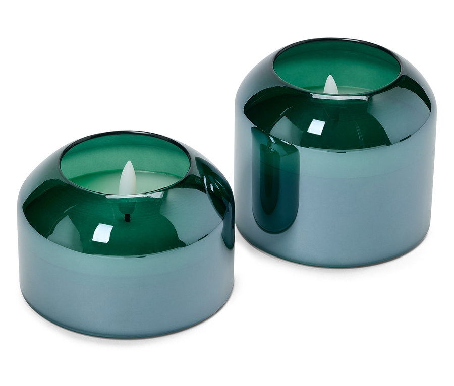 Deux bougeoirs bleu-vert arrondis avec des bougies LED à l'intérieur.