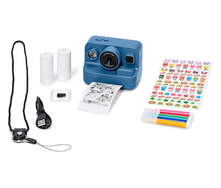 Caméra bleue avec accessoires, comprenant du papier, des autocollants, des marqueurs et un câble USB.