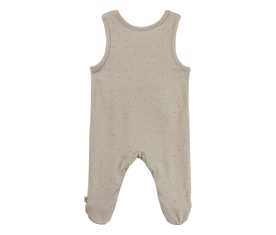 Grenouillère bébé beige sans manches avec pieds intégrés et un motif à pois discret.