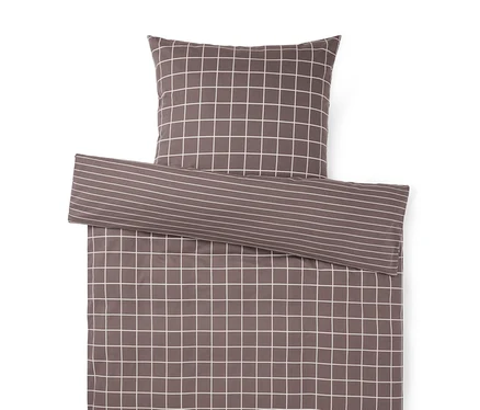 Parure de lit anthracite avec motif à carreaux blancs. Une partie repliée révèle un motif à rayures.
