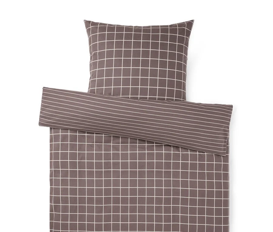 Parure de lit anthracite avec motif à carreaux blancs. Une partie repliée révèle un motif à rayures.