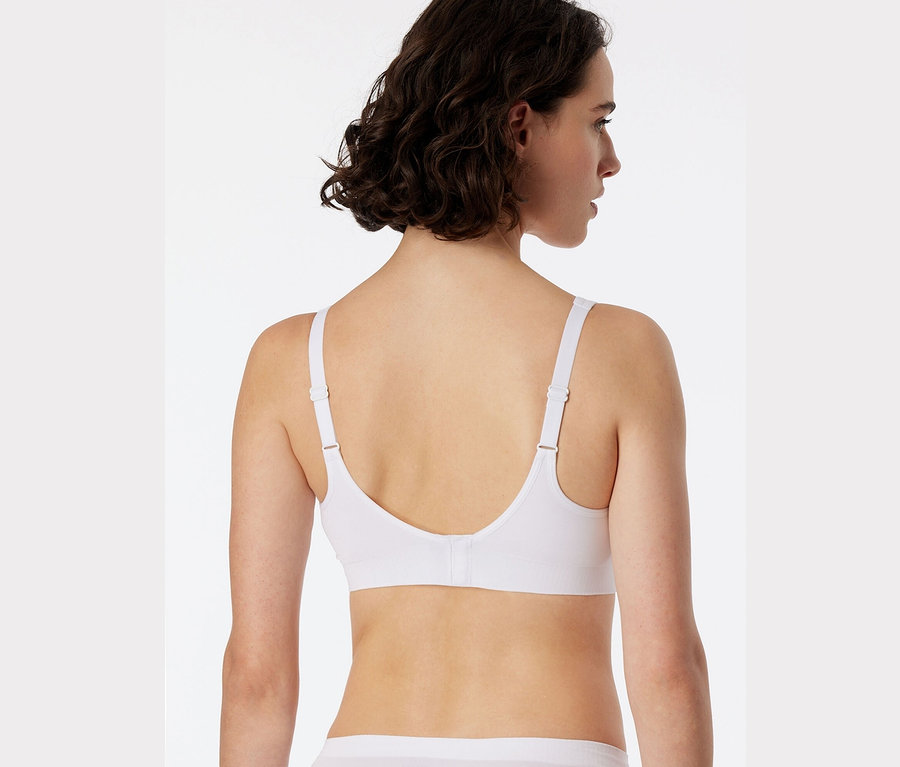 Vue arrière d'une femme aux cheveux bruns portant une brassière douce SCHIESSER blanche avec coussinets.