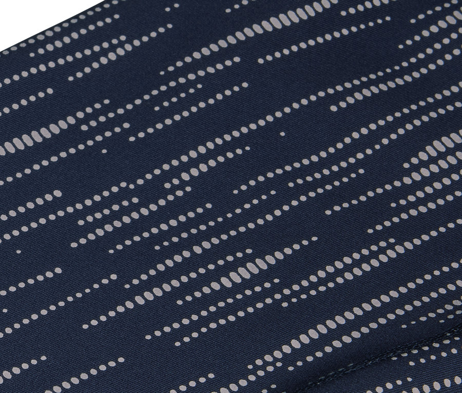 Gros plan d'un tissu bleu marine avec un motif de points blancs parallèles.